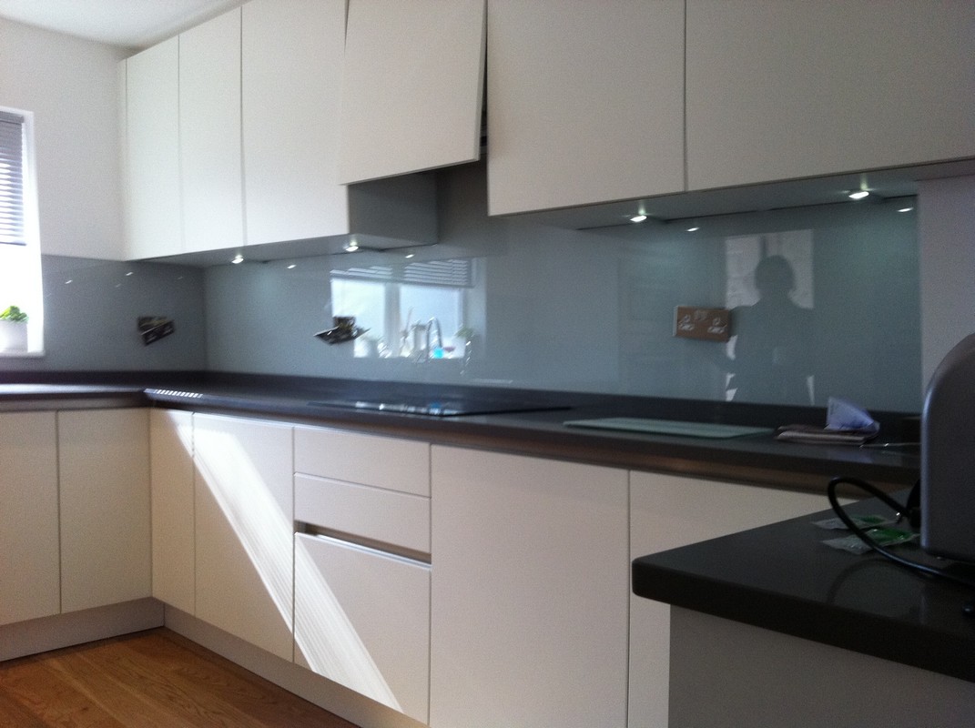 Grey glass kitchen splashback with LED lighting in Mile End
