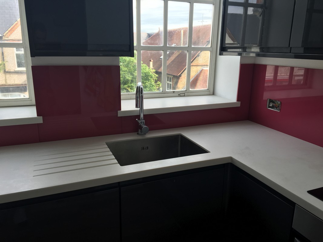 Deep plum coloured glass splashback in modern Mile End kitchen